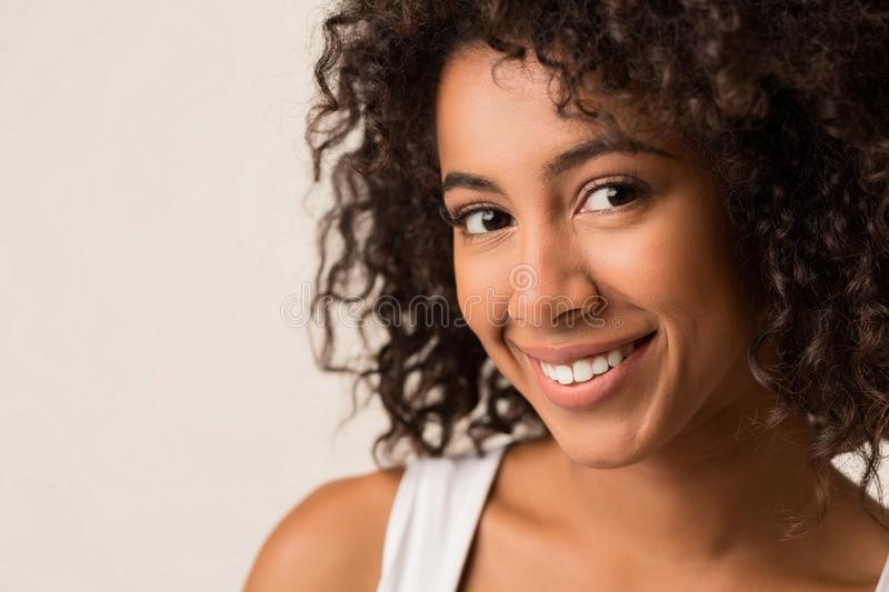 happy-african-american-woman-curly-afro-hair-happy-african-american-woman-curly-hair-standing-against-light-background-128597134